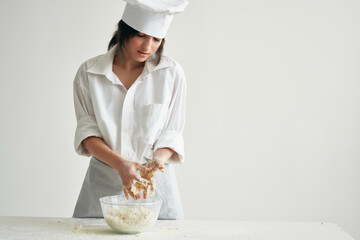 Wall Mural - woman chef uniform works with dough flour products cooking food