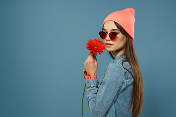 Wall Mural - woman with red flower in hands pink hat fashionable clothes glamor