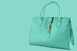 © aneduard - turquoise womens bag with handles, on a turquoise background, diagonal arrangement, concept