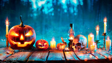 Halloween At Night - Jack O Lantern On Table With Candles In Forest