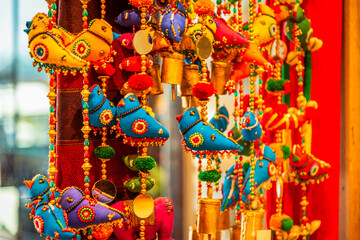 Traditional handmade cloth birds and wooden beads Rajasthani wall hanging (strings) handicraft in the streets market of India.