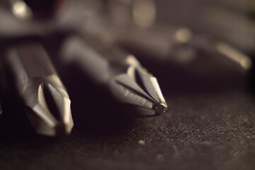 Canvas Print - Selective focus shot of screwdriver bits on a dark surface