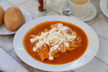 Wall Mural - Red Enchiladas - traditional mexican food with tomato sauce and cheese in Mexico