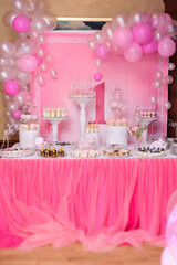 Wall Mural - A candy bar with sweets in pink tones for a baby 