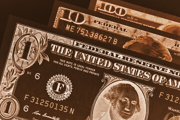 Wall Mural - us banknotes of 1, 10 and 100 dollars close up. dark brown inverted and tinted illustration. taxes, 