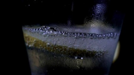 Poster - A closeup of a transparent glass cut being filled with soda