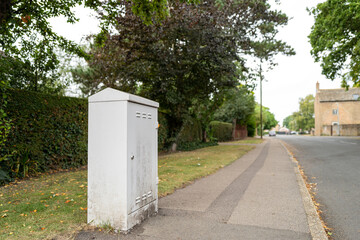 Typically styled telecoms and Internet street cabinet used for voice, cable TV and Broadband Internet services. Seen in a quiet rural village.