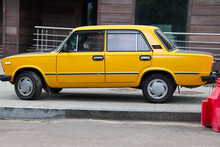 Bright Yellow Soviet Car And Cloudy Day