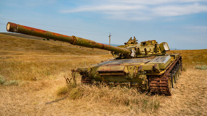 old rusty tank stands in a field