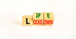 © Dzmitry - Life with lockdown symbol. Turned wooden cubes and changed words 'lockdown' to'life'. Beautiful white background. Covid-19 pandemic and life with lockdown concept. Copy space.