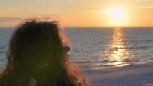 Sunset In Seaside, Santa Rosa Beach, Florida In Panhandle With Closeup Woman In Silhouette With Long Hair Looking Watching Sun Path Reflection Sunset At Gulf Of Mexico 
