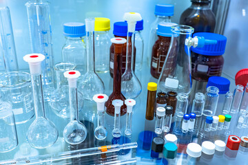 Poster - Empty laboratory glassware. laboratory glassware on a glass shelf. Various glass test tubes. Test tubes for chemical experiments. Laboratory glassware for medical clinic. Pharmaceutical lab flasks
