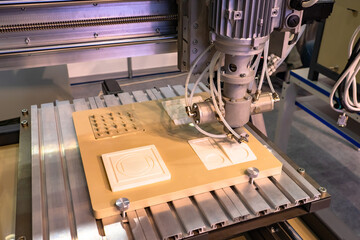 Poster - Milling machine during work. Laser milling machine is cutting something. Milling equipment close up. Equipment in a steel workshop. Cutting white wood plates. Equipment in a furniture shop