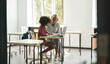 © insta_photos - Female teacher or tutor helping African American kid child girl student with homework learning doing hometask sitting at desk in classroom. After school education and day care studies concept.