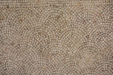 Wall Mural - Overhead shot of cobblestone pavement in shell or arched pattern