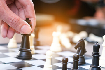 The hands of the people on the competition and the strategic planning guidelines on the checkmate board. Succeed