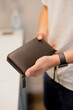 Man holding his leather wallet in a hands