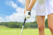Golfer Wearing A Golf Holding A Putter.