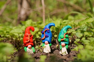 Canvas Print - Figurines of three colorful dwarfs made of plasticine.