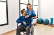 © Krakenimages.com - Young disabled man making mobility exercise sitting on wheelchair at the clinic.