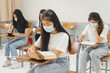 © EduLife Photos - Asian college students back to school wear protective facemask and keep social distance studying in the classroom