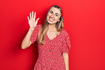 Poster - Beautiful hispanic woman wearing summer dress showing and pointing up with fingers number five while smiling confident and happy.