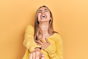 Sticker - Beautiful hispanic woman wearing casual yellow sweater laughing at you, pointing finger to the camera with hand over body, shame expression