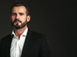 © halayalex - Closeup portrait of handsome confident stylish hipster lambersexual model. Sexy modern man dressed in elegant black suit. Fashion male posing in studio on dark background. Looking at camera
