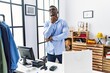 © Krakenimages.com - Young african man working as manager at retail boutique thinking worried about a question, concerned and nervous with hand on chin