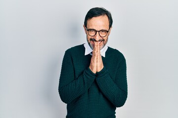 Poster - Middle age hispanic man wearing casual clothes and glasses praying with hands together asking for forgiveness smiling confident.