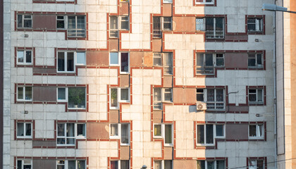 Frontal view of a building facade with many windows, pattern