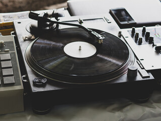 DJ playing music at a hip hop party. analog turntable, Dj uses turntable and mixer for scratching.