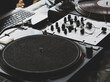 © Максим - DJ playing music at a hip hop party. analog turntable, Dj uses turntable and mixer for scratching.