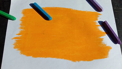 Poster - Picture painted with an orange crayon on the paper with other colorful crayons on it