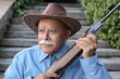 Senior Mexican rancher with a riffle