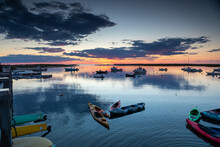 Sunset Over Bay With Kayaks