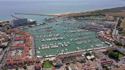 Canvas Print - Aerial video of the tourist Portuguese town of Vilamoura, with views of the beaches and docks for luxury yachts, hotels and restaurants. Portugal, Algarve.