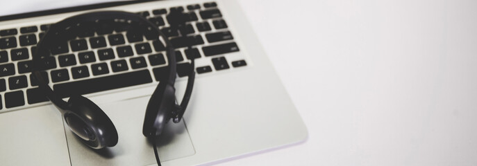 Laptop computer and headphone on desk, e-learning online, webinar for education and learning, seminar with notebook, video conference, headset for multimedia, course and classroom to internet.