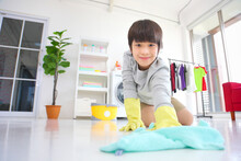 Asian Boy Help Cleaning The Floor For Daily Routine Chores And Housekeeping
