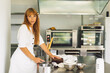 © Анастасія Стягайло - Confectioner girl is preparing a cake biscuit with white cream and chocolate. Cooking cakes.