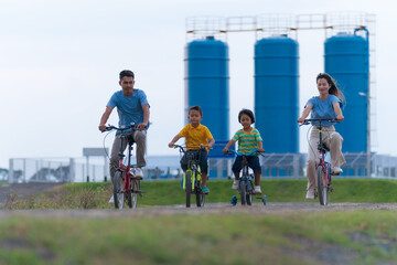 Wall Mural - Happy family cycling on bikes outdoors