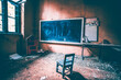 Vintage old destroyed classroom inside abandoned school with chalk board