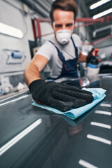 Sticker - Hand pressing cloth to automobile surface while cleaning