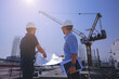 © Panumas - Structural engineer and foreman worker with blueprints discuss, plan inspecting for the outdoors building construction site.