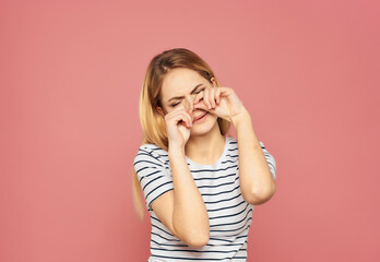 Wall Mural - pretty woman in a striped T-shirt discontent upset studio isolated background