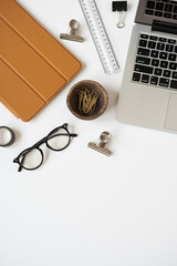 Wall Mural - Aesthetic home office desk workspace with laptop computer, tabled pad, stationery stuff on white background. Flat lay, top view blog, website, social media concept with clean copy space