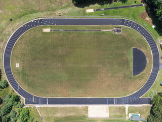 Top-down aerial photo of a black-colored running track