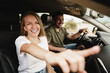 © fotofabrika - Beautiful young couple sitting on front passenger seats and driving a car