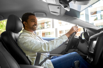 transport, vehicle and people concept - happy smiling indian man or driver driving car