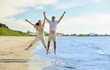 © Syda Productions - leisure, relationships and people concept - happy couple jumping on summer beach